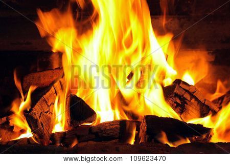 A nice fire with coals in a fire place close