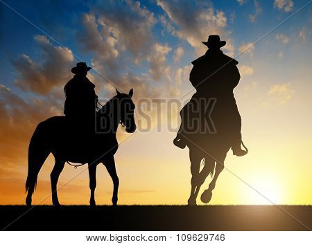 Silhouette cowboy with horse in the sunset 
