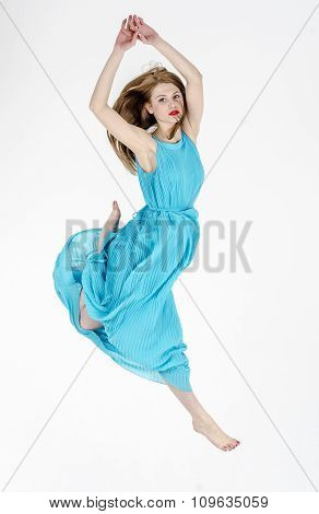 A slender girl  dancing in a summer dress