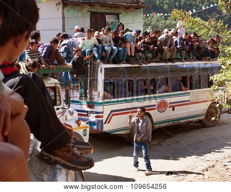 People Traveling On Top Of Autobus Brand Tata