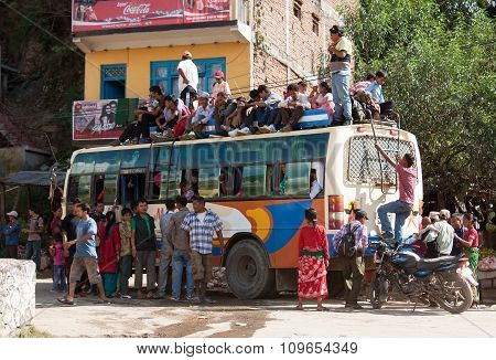 People Traveling On Top Of Autobus Brand Tata