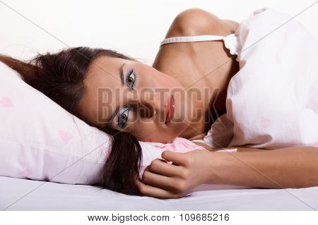 Young woman laying and sleeping on the bed