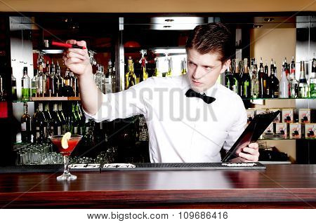 Young Handsome Bartender Waiting An Order.