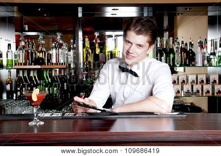 Young Smiling Bartender Taking An Order.