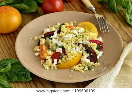 Millet with basil and fresh tomatoes and goat cheese
