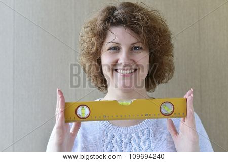 woman is holding construction tools
