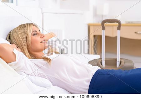 Female tourist resting in her bed.