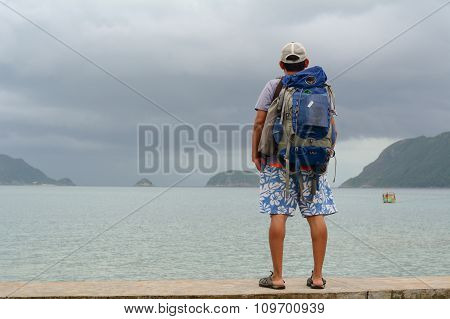 Young Men Standing And Seeing The Sea
