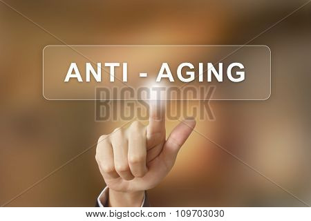 Business Hand Clicking Anti Aging Button On Blurred Background