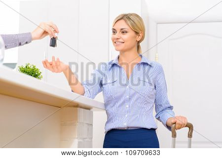 Young lady receiving her room key.