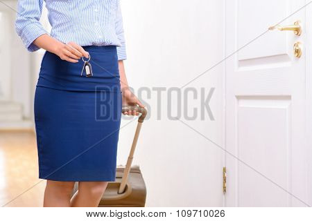 Female traveller is standing in the hallway.