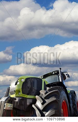 Big Tractor On Background Of The Cloudy Sky