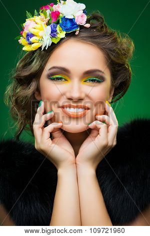 Beautiful young woman with flowers on head