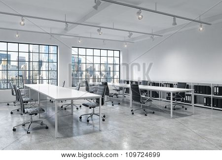 Workplaces In A Bright Modern Loft Open Space Office. Empty Tables And Docents' Book Shelves. New Yo