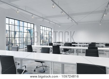 Workplaces In A Bright Modern Loft Open Space Office. Empty Tables And Docents' Book Shelves. New Yo