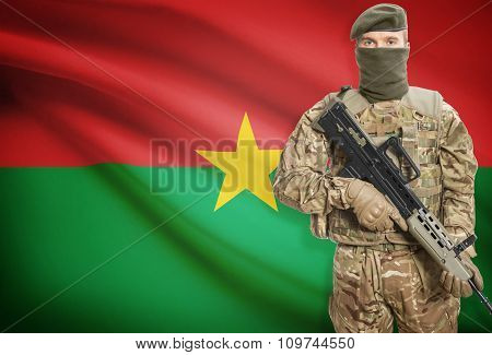 Soldier Holding Machine Gun With Flag On Background Series - Burkina Faso