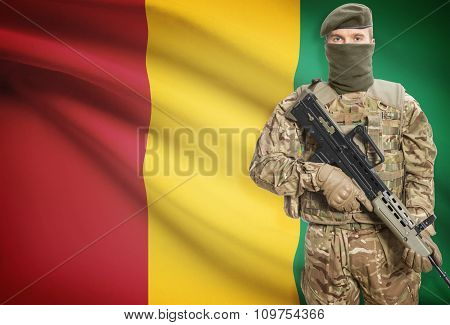 Soldier Holding Machine Gun With Flag On Background Series - Guinea