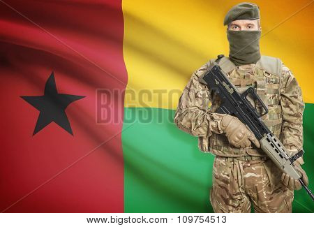 Soldier Holding Machine Gun With Flag On Background Series - Guinea-bissau