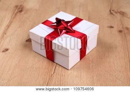 New Year gift on a golden tinsel background boly