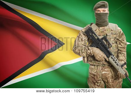 Soldier Holding Machine Gun With Flag On Background Series - Guyana