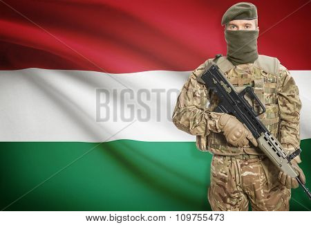 Soldier Holding Machine Gun With Flag On Background Series - Hungary
