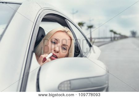 Woman Apply Rose Lipstick Looking In Car Mirror
