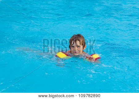 little boy having fun in an swimming pool