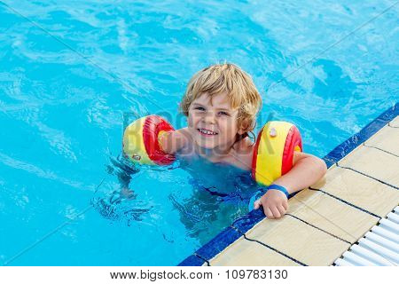 little boy having fun in an swimming pool