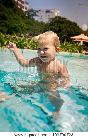 Closeup Small Blonde Girl Smiles Looks Into Water In Pool