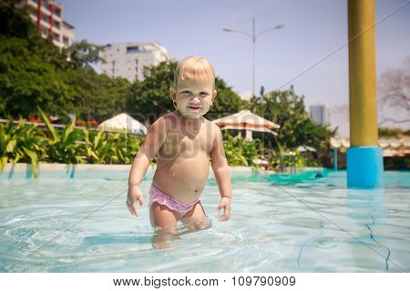 Small Blonde Girl Bathes Smiles Plays In Hotel Swimming Pool