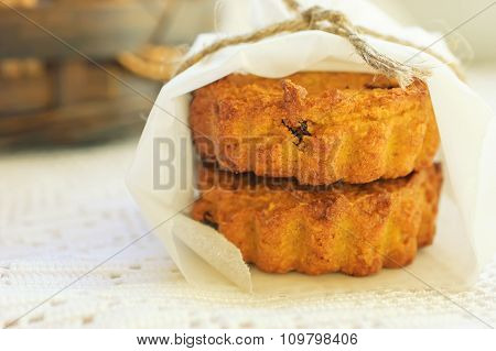 Homemade rustic muffins with pumpkin and oatmeal on bowl with white greaseproof paper.