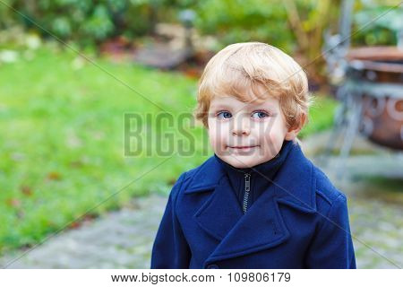 Portrait of little toddler boy on autumn day