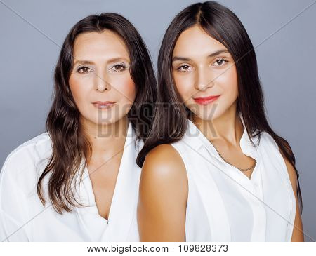 cute pretty teen daughter with mature mother hugging, fashion style brunette makeup close up tann mu