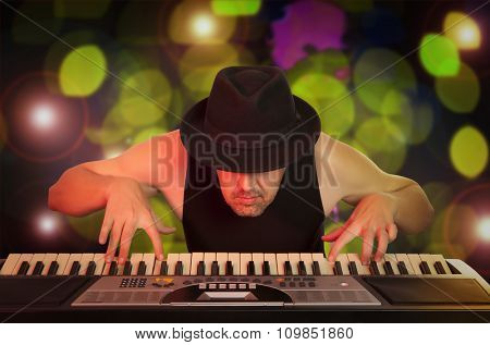 Man in the hat playing on a synthesizer