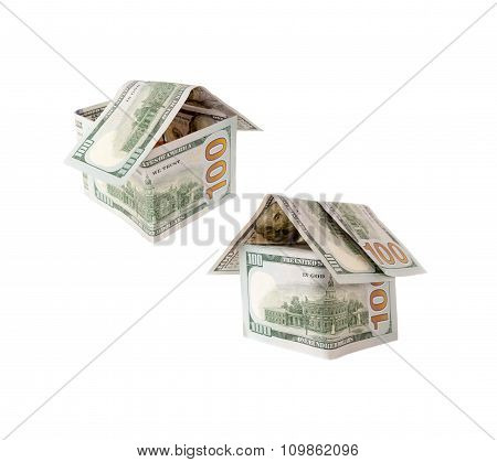 Two Houses of one hundred dollar bills on white.