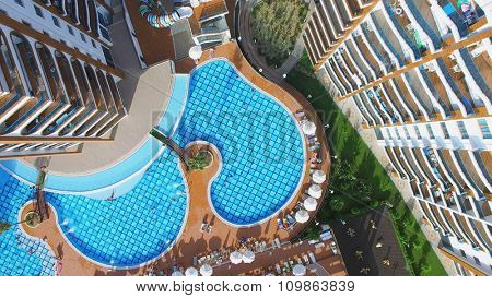ALANIA - AUG 16, 2015: People get rest on pool side of Residential complex Azura Park at summer sunny day. Aerial view videoframe
