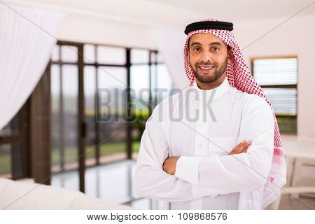 portrait of happy arabian man standing indoors