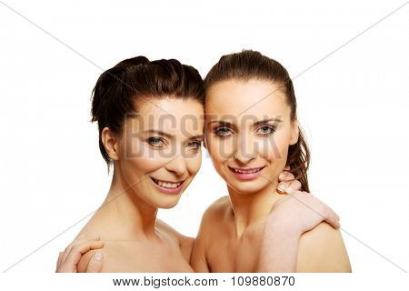 Two attractive sisters with make up embracing.