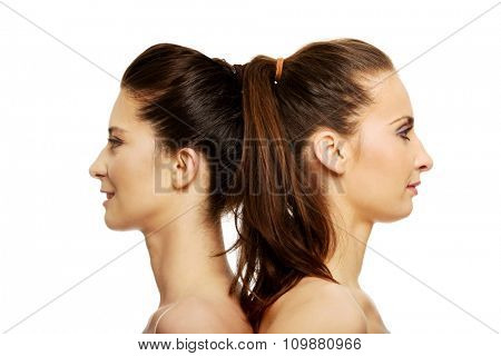 Two attractive topless sisters with make up.