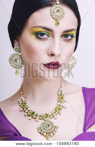 young pretty caucasian woman like indian in ethnic jewelry close up