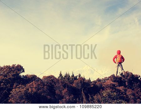 young woman hiker hiking on mountain peak
