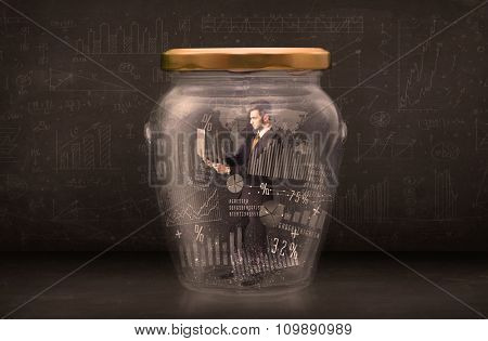 Businessman traped in jar with graph chart symbols concept on background