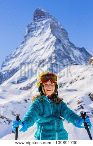 Skier girl with view of Matterhorn on a clear sunny day - Zermatt, Switzerland