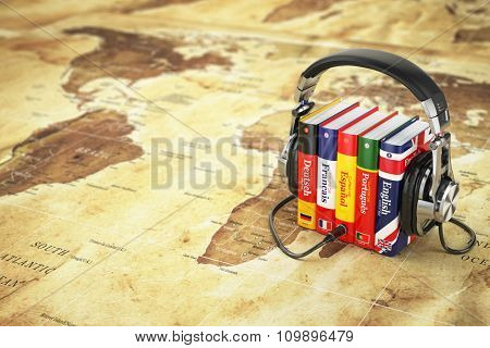 Learning languages online. Audiobooks concept. Books and headphones on the map world. 3d