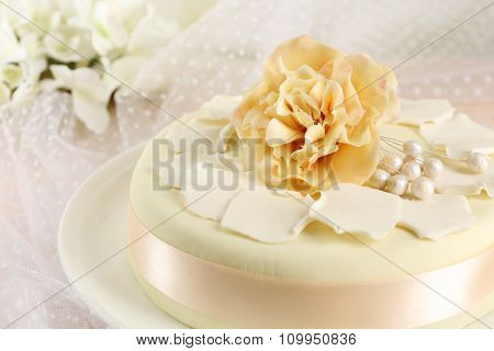 Cake with sugar paste flowers, on light background