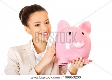 African business woman with a piggybank.