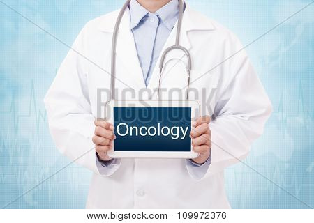 Doctor holding a tablet pc with Oncology sign on blue background
