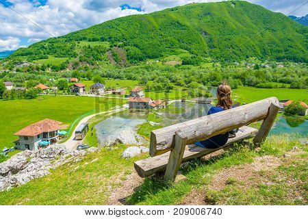 A Young Girl Dreams On A Wooden Bench Near The Sources Of Ali Pasha.