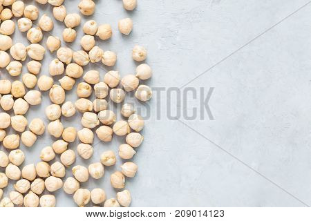 Uncooked dry chickpeas on concrete background horizontal copy space closeup