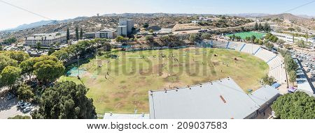 WINDHOEK NAMIBIA - JUNE 17 2017: An aerial panorama of the eastern parts of Windhoek the capital city of Namibia. The Tintenpalast Windhoek High School and its sport stadium are visible